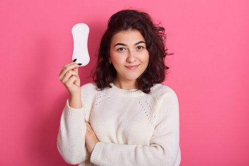 Woman holding a panty liners, promoting daily hygiene and feminine care products.